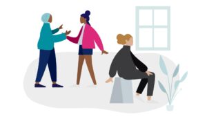 two colleagues discuss an individual in their care, who is sitting away from them.